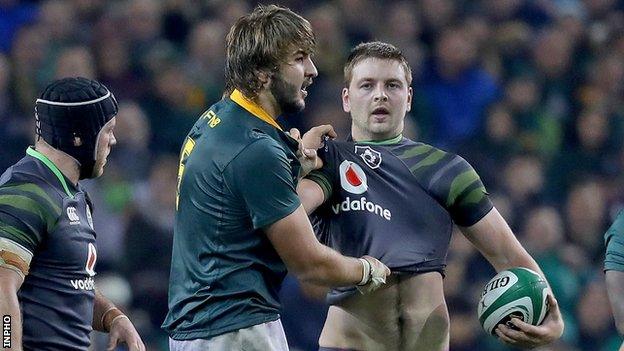 Iain Henderson indulges in a spot of jersey putting with South Africa's Load de Jager