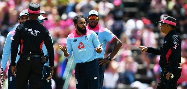 Adil Rashid talks to the umpires