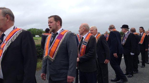 The Orangemen parade into the seaside village before a religious service