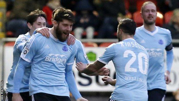 Will Evans (left) celebrates a goal for Aldershot