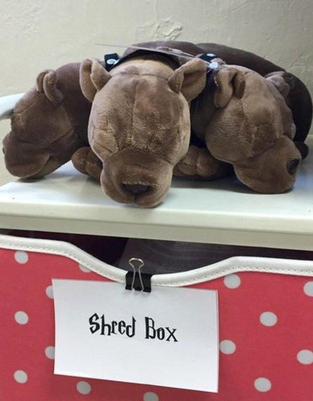 A three-headed dog, like Fluffy from the Potter books, guards a drawer.