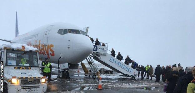 Northampton Saints fans and staff board the plane