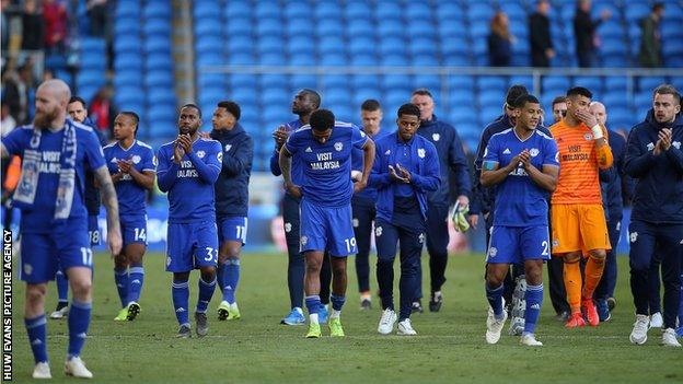 Dejected Cardiff players salute their fans after the loss to Palace confirmed their return to the Championship