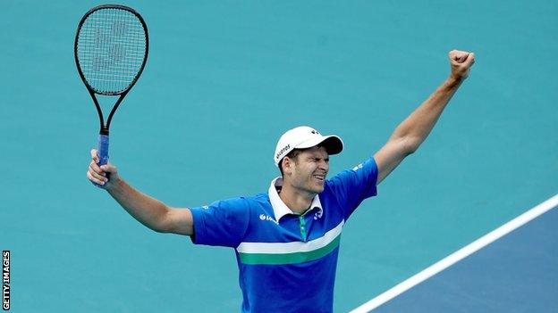 Poland's Hubert Hurkacz holds his arms aloft in celebration after beating Jannik Sinner to win the 2021 Miami Open men's singles title