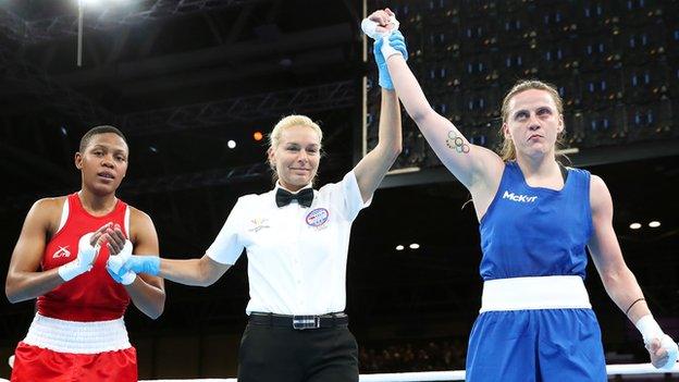 Michaela Walsh's arm is held aloft as she is declared the victory in the featherweight semi-final