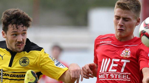 Cliftonville's Tomas Cosgrove in action against Christian Stewart of Portadown