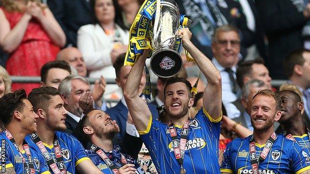 Jon Meades lfts the League Two play-off final trophy after AFC Wimbledon's 2-0 win over Plymouth Argyle