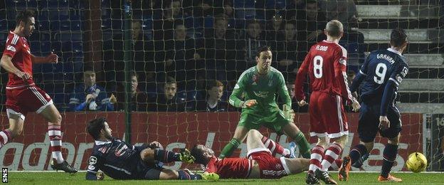 Brian Graham (right) pounces to put Ross County 1-0 up before half-time