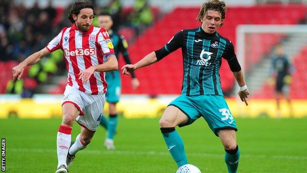 Stoke City's Joe Allen in action against Swansea City's Conor Gallagher