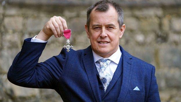 John McGauinness holding up his MBE