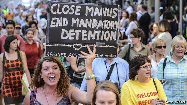 A group of people hold placards during a protest in Melbourne, Australia on 22 January, 2015 to support the Manus Island asylum seekers and call for an end to offshore processing