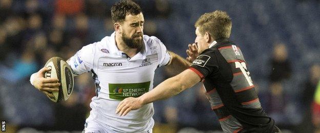 Alex Dunbar of Glasgow is tackled by Edinburgh's James Johnstone