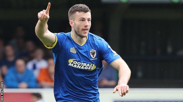 Jon Meades celebrates scoring a goal for AFC Wimbledon