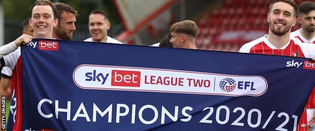 Cheltenham players celebrate winning League Two