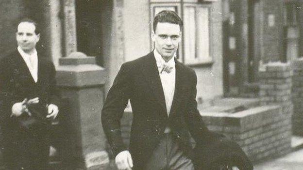 Edward 'Taffy' Bowen in a suit outside some houses on his wedding day in 1938