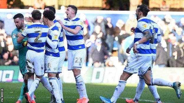 QPR players celebrate Liam Kelly's penalty save