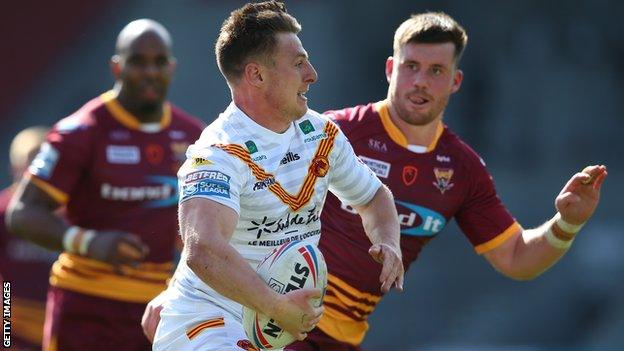 Tom Davies of Catalans Dragons makes a break against Huddersfield Giants