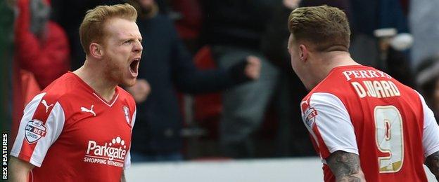 Chris Burke (left) celebrates with Rotherham United