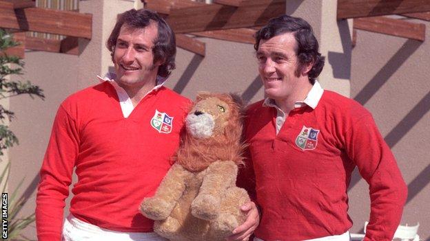 Sir Gareth Edwards and Phil Bennett in Lions kit with a toy lion in 1974