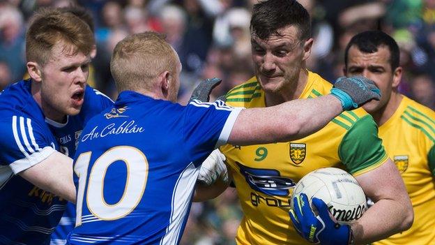 Cavan players attempt to halt the run of Donegal's Leo McLoone in the preliminary round game