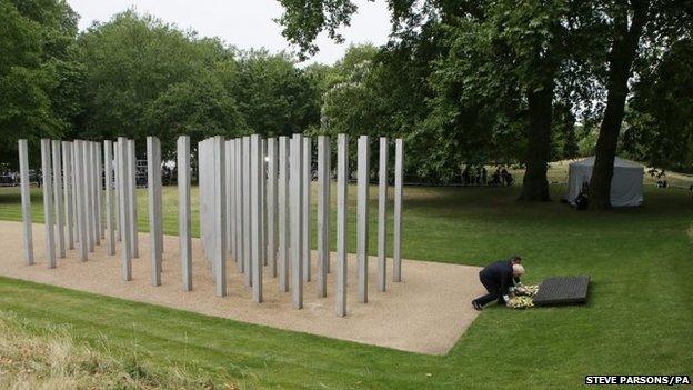 London Mayor Boris Johnson and British Prime Minister David Cameron carry wreathes at the July 7 memorial in Hyde Park, London