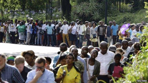 People queue to view the body of Nelson Mandela lying in state in Pretoria on 11 December 2013