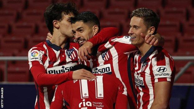 Atletico Madrid's Luis Suarez celebrates with teammates