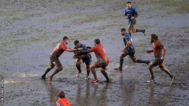 Newport Gwent Dragons take on Newcastle Falcons on a water-logged Rodney Parade pitch