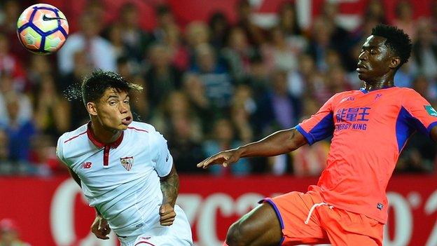 Sevilla's Joaquin Correa (left) heads the ball past Granada's Martin Hongla