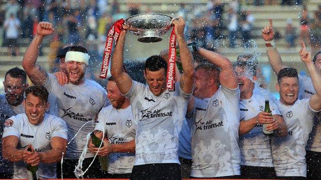 Toronto captain Craig Hall lifts the League One title