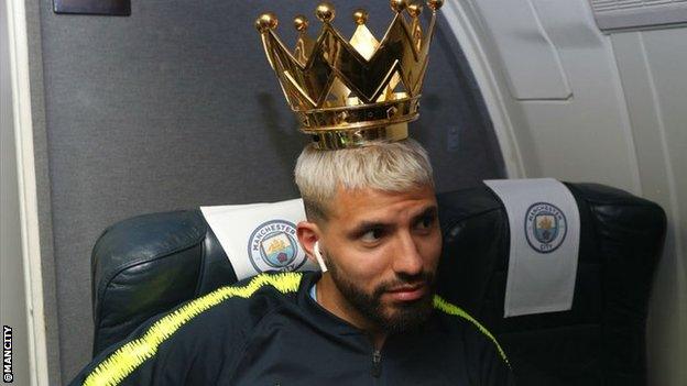 Sergio Aguero wears the crown of the Premier League trophy on his head