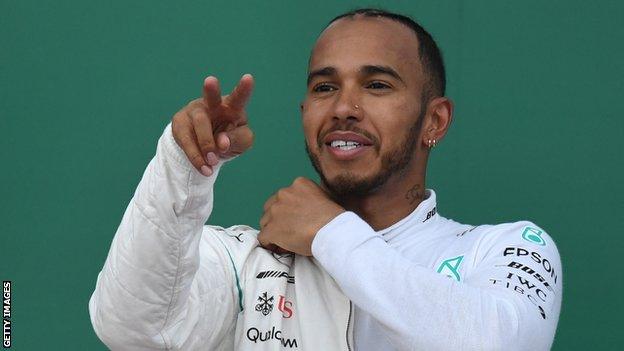 Mercedes driver Lewis Hamilton celebrates on the podium after winning the Azerbaijan Grand Prix