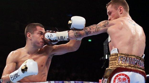 Scott Quigg (left) takes a punch from Carl Frampton