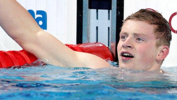 Adam Peaty celebrates in the pool