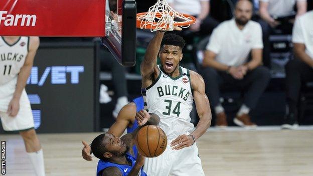 Milwaukee Bucks star Giannis Antetokounmpo dunks over Gary Clark of the Orlando Magic