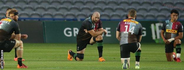 Harlequins players take a knee