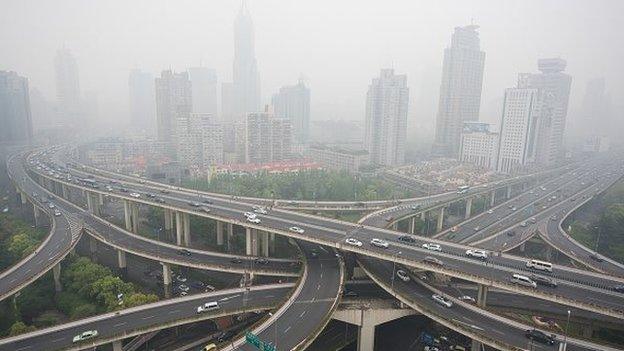 Cars are seen on an elevated road on a heavy polluted day in Shanghai on April 19, 2015. AFP PHOT