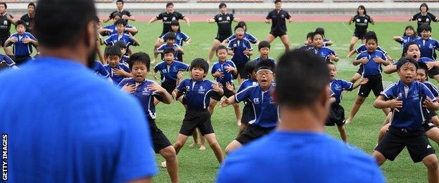 Schoolchildren perform a haka for the All Blacks