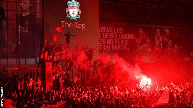 Liverpool fans celebrate winning the league at Anfield