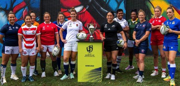 The 12 captains pose with the trophy ahead of the 2021 Rugby World Cup