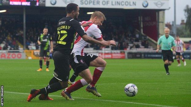 Brendan Galloway tackles Lasse Sorensen