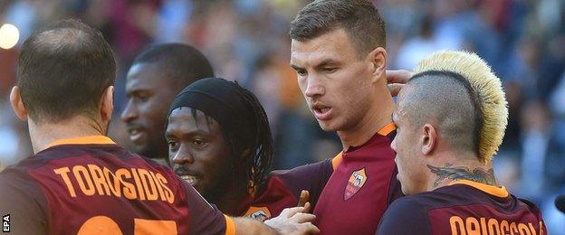 Edin Dzeko celebrates scoring against Lazio