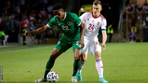 Chiedozie Ogbene of Republic of Ireland is challenged by Szabolcs Schon after being introduced