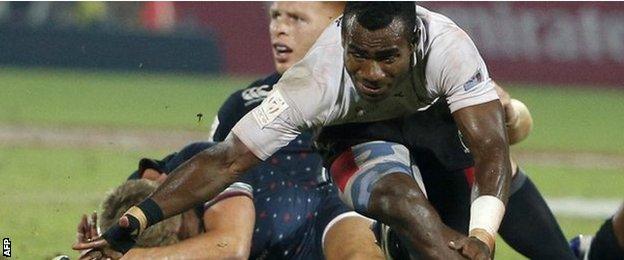 Jerry Tuwai (right) fights for the ball with England's Tom Mitchell