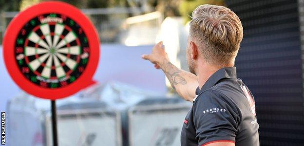 Kevin Magnussen plays darts
