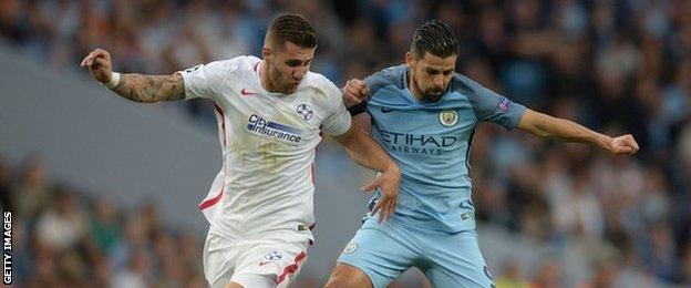 Steaua Bucharest's Romanian midfielder Ovidiu Popescu (left) in action against Man City