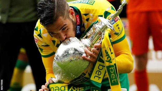 Emi Buendia celebrates with the Championship trophy