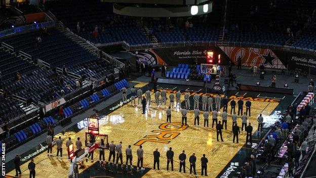 Orlando Magic and Denver Nuggets holding a moment of silence