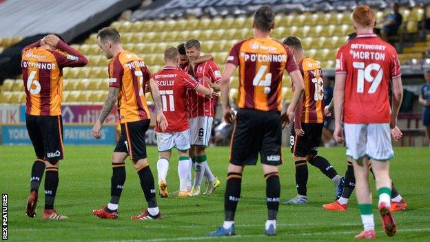 Lincoln City's players celebrate after scoring against Bradford City in the Carabao Cup