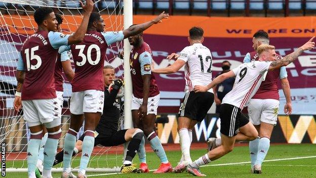 Aston Villa keeper Orjan Nyland tries to prevent a goal